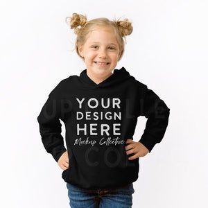 May include: A black hooded sweatshirt with the text "YOUR DESIGN HERE" and "Mockup Collective" printed on the front.