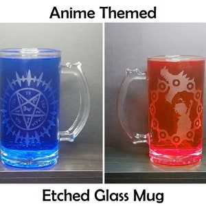 May include: Two etched glass mugs with anime-themed designs. The mug on the left has a blue liquid and a pentagram design. The mug on the right has a red liquid and a dragon design.