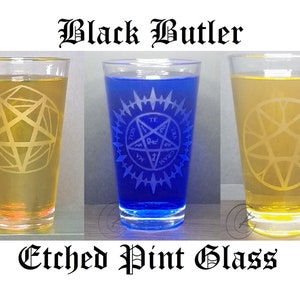 May include: Three etched pint glasses with different colored liquids. The glasses feature a pentagram design with the words "Black Butler" at the top and "Etched Pint Glass" at the bottom.