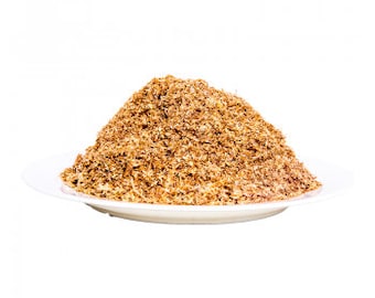 May include: A pile of light brown dried seaweed flakes on a white plate.