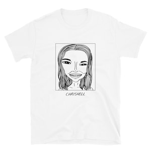 May include: A white t-shirt with a black and white line drawing of a woman's face with the text "CHRISHELL" underneath.