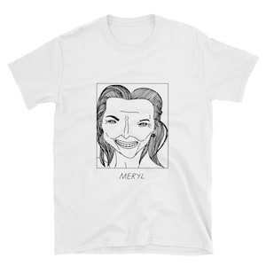 May include: White t-shirt with a black and white line drawing of a woman's face. The drawing is in a square frame with the word "MERYL" underneath.