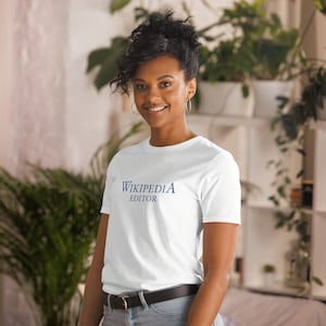 May include: A white t-shirt with the text "Wikipedia Editor" printed in blue on the front.