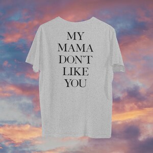 May include: Gray t-shirt with the text "MY MAMA DON'T LIKE YOU" printed on the back.
