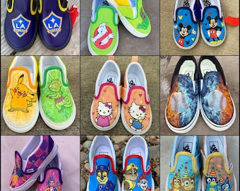 May include: A collection of nine pairs of custom-painted slip-on trainers featuring various pop culture characters and logos, including LA Galaxy, Ghostbusters, Mickey Mouse, Pikachu, Hello Kitty, baseballs, anime figures, Paw Patrol, and Bluey.