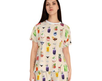 May include: A beige pajama set with a short-sleeved shirt and shorts. The shirt and shorts are covered in a pattern of colorful cocktails and drinks.