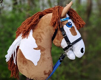 BROWN AND WHITE spotted hobby horse with tack/bridle
