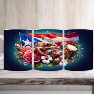 May include: White ceramic mug featuring a vibrant design with the Puerto Rican flag, a frog, flowers, and musical instruments. The design is set against a dark blue background. The mug is displayed on a wooden surface.