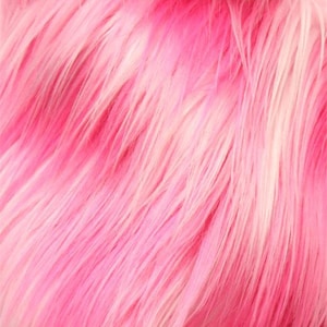 May include: Close-up of a pink faux fur fabric with long, soft fibers. The fabric has a gradient of colors, ranging from a deep, vibrant pink to a lighter, almost white shade. The texture is fluffy and dense, creating a luxurious appearance.
