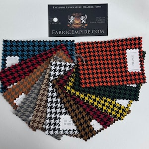 May include: A collection of fabric swatches in various houndstooth patterns, including black and white, red and black, orange and black, and teal and black. The swatches are arranged in a fan shape, with the label "ORANGE" visible on one of the swatches.