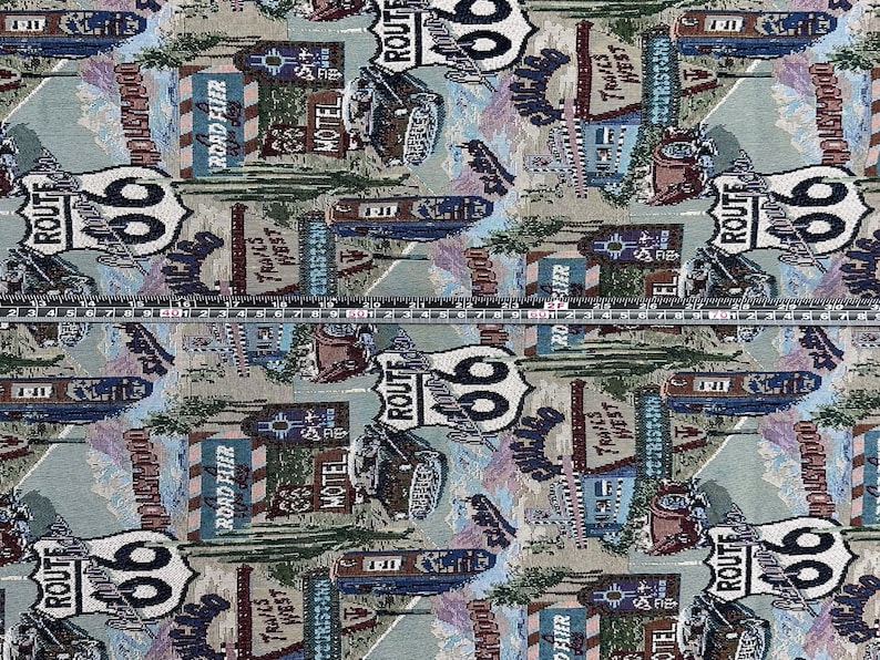 May include: A colorful fabric with a repeating pattern of Route 66 signs, motel signs, and vintage cars. The fabric is a light beige color with blue, red, and green accents.