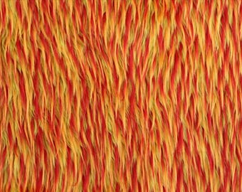 May include: Close-up of a textured fabric with a shaggy appearance. The fabric features a blend of red, yellow, and orange fibers, creating a vibrant and warm color palette. The fibers are long and flowing.