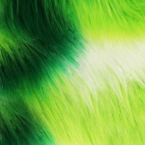 May include: Close-up of a vibrant, textured fabric with a gradient of green hues. The material transitions from a deep, dark green to a bright, lime green, with a white stripe. The fabric has a soft, furry appearance, suggesting a plush or faux fur material.