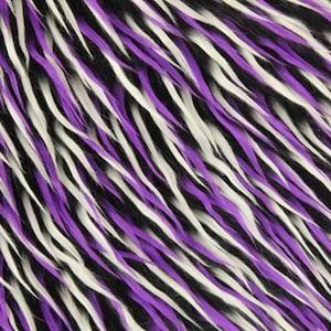 May include: Close-up of a faux fur fabric with a striped pattern. The fabric features long, wavy strands in black, white, and purple. The strands are arranged diagonally, creating a textured and visually dynamic surface.