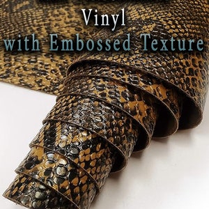 May include: Rattlesnake Vinyl with Embossed Texture. A close-up of a roll of brown and black vinyl with a snakeskin pattern.