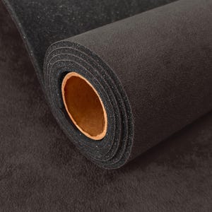 May include: A roll of black foam-backed fabric featuring a textured, matte surface on the exterior and a smooth, porous foam layer on the interior. The roll is wound around a cylindrical cardboard core with a light brown, circular opening.