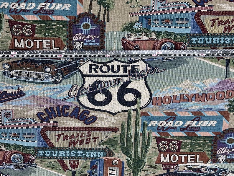 May include: A colorful tapestry featuring a Route 66 theme with a vintage car, motel signs, and a cactus. The text "Get your kicks on Route 66" is prominently displayed on a blue and white sign.