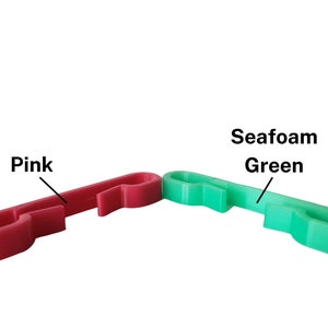 Pink and seafoam green sternum clips for string backpack