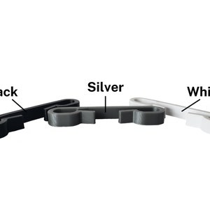 Black, silver, and white sternum clips for string backpack