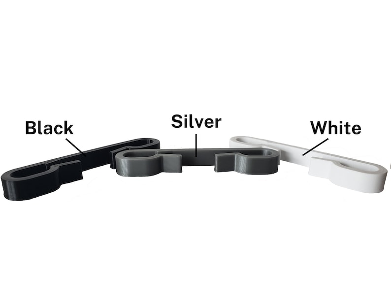 Black, silver, and white sternum clips for string backpack