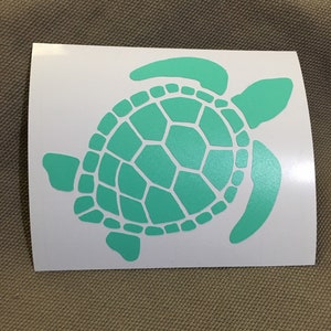 May include: A teal green sea turtle silhouette decal. The turtle has a detailed shell with a segmented pattern.