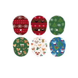 May include: Six oval Christmas patches with festive patterns. Designs include snowflakes, Mickey Mouse heads, Christmas trees, gingerbread men, and candy canes in red, green, white, and blue colours.
