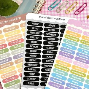 May include: Three sets of stickers with different color schemes and designs. Each set features the days of the week, with the words "Monday", "Tuesday", "Wednesday", "Thursday", "Friday", "Saturday", and "Sunday" printed on each sticker. The first set is in earth tones, the second set is in black, and the third set is in pastel colors.
