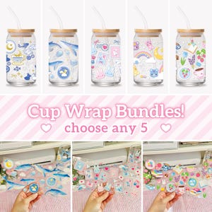 May include: Five clear glass tumblers with bamboo lids and glass straws, each featuring unique colourful decals including whales, bunnies, rainbows, and floral patterns. Below, three transparent adhesive sheets display the same graphic designs.