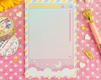 May include: A pastel-colored notepad with a grid pattern, designed with a dreamy aesthetic. The notepad features a cloud and star motif at the bottom, with a window-like frame. Decorative washi tape, a pen, and paperclips are also visible.