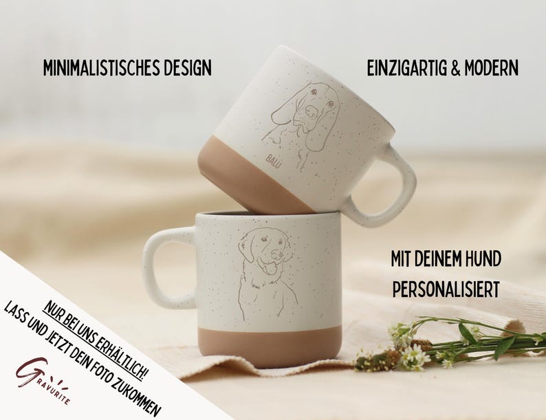 May include: Two white ceramic mugs with a speckled finish and tan bottoms. Each mug features a line drawing of a dog's face. The text on the mugs says "Minimalist Design", "Unique & Modern", and "Personalized with your dog".
