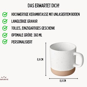May include: A white ceramic mug with a speckled design and a tan base. The mug is 8.8 cm wide and 8.9 cm tall, with a capacity of 360 ml. Text in German reads "DAS ERWARTET DICH!" and lists features like high-quality ceramic and personalization.