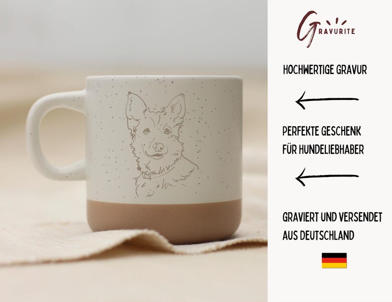 May include: A speckled ceramic mug with a cream-colored handle and upper half, and a tan-colored lower half. The mug features a detailed line drawing of a dog's face. The text on the right side says "Hochwertige Gravur" and "Perfekte Geschenk f&uuml;r Hundeliebhaber."
