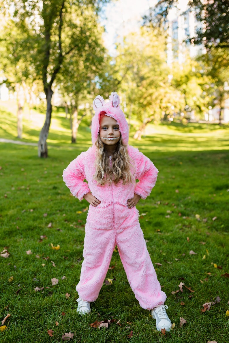 Full body view of the pink fleece monster jumpsuit