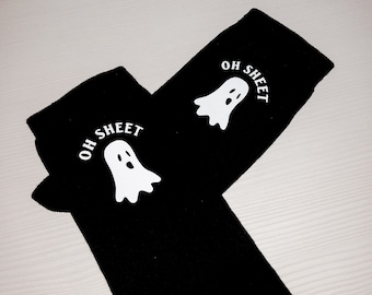 May include: Two black socks with a white ghost and the text "OH SHEET" on each sock.
