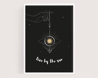 live by the sun wall art print | abstract sun print | inspirational quote | hand holds sun | celestial | black, white and gold | boho decor