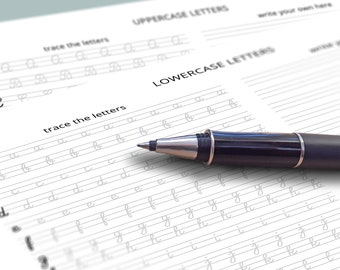May include: A close-up of a handwriting practice worksheet with lowercase letters printed in cursive. A black pen is lying on the page, ready to trace the letters.