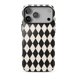 May include: A smartphone case featuring a repeating black and off-white diamond harlequin pattern. The upper section includes a rectangular camera cutout area with three circular lens openings and a small circular flash aperture in a light gray finish.