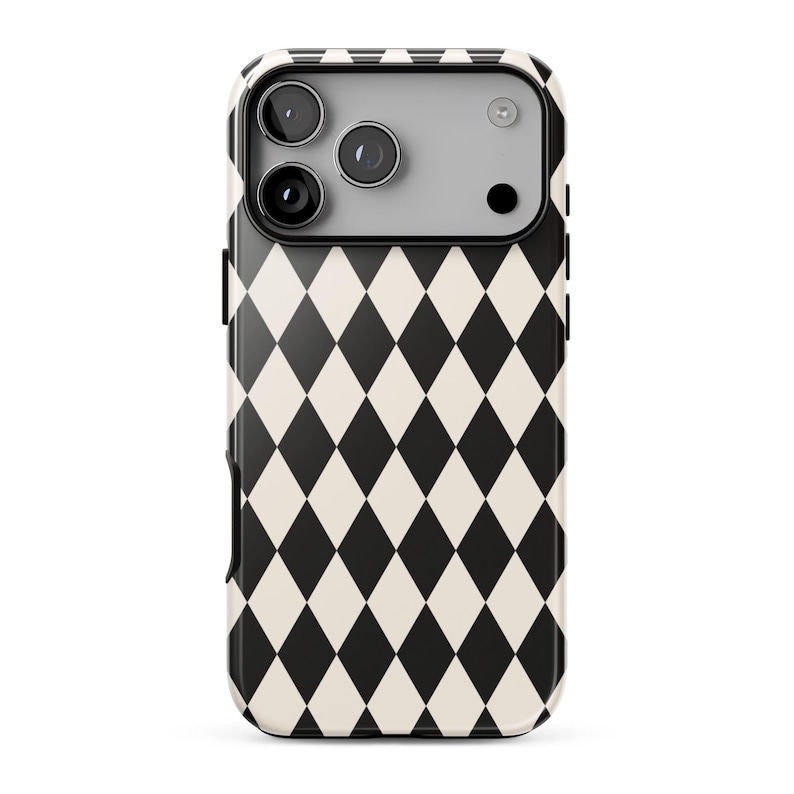 May include: A smartphone case featuring a repeating black and off-white diamond harlequin pattern. The upper section includes a rectangular camera cutout area with three circular lens openings and a small circular flash aperture in a light gray finish.