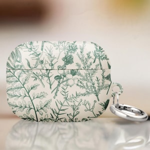 Può includere: Una custodia bianca per Airpods con un motivo floreale verde e un portachiavi in metallo argentato.