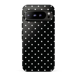 May include: A black smartphone case featuring a repeating white polka dot pattern across the entire surface. The case includes a horizontal camera cutout at the top, revealing three circular camera lenses and a flash component on the device.