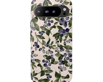 May include: A smartphone case featuring a repeating pattern of dark blue blueberries and green leaves on a light cream background. The case has a black horizontal camera bar at the top with three circular lens cutouts and a flash opening.