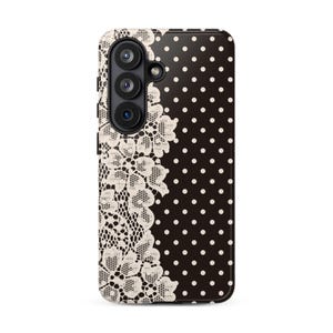 May include: A black smartphone case featuring a split design. The left side displays an intricate cream-colored floral lace pattern, while the right side features a classic white polka dot print on a solid black background.