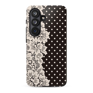May include: A black and white phone case with a floral lace design on the left side and white polka dots on the right. The case has a camera module on the upper left.