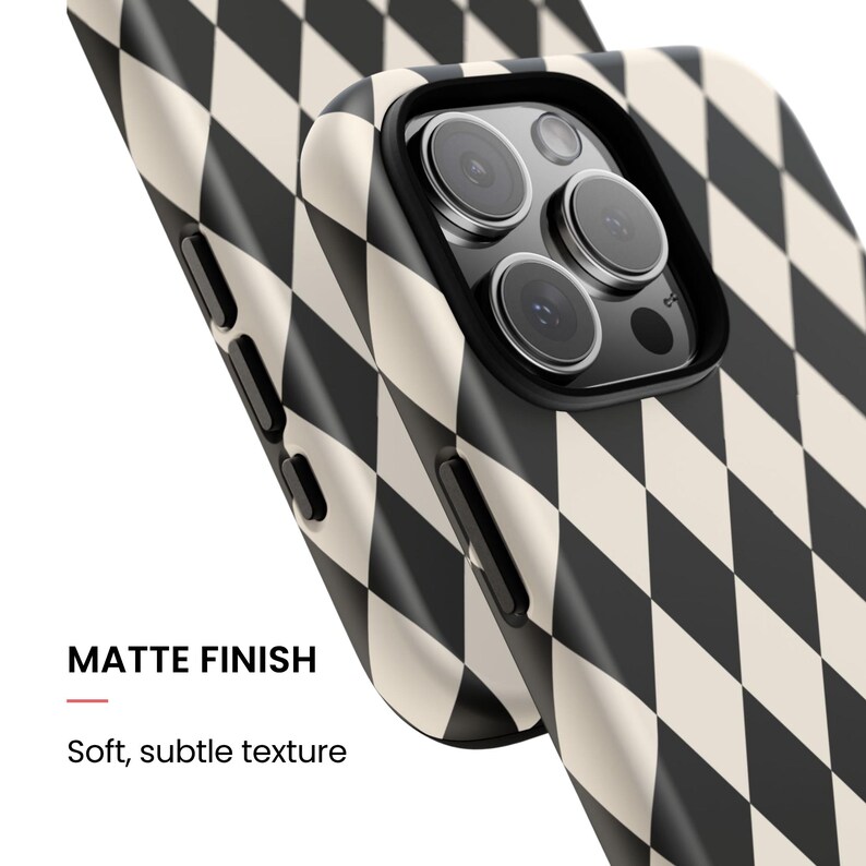 May include: A smartphone case featuring a black and cream diamond harlequin pattern with a matte finish. The case has a soft, subtle texture and includes cutouts for the camera lenses and side buttons. The text MATTE FINISH is visible.
