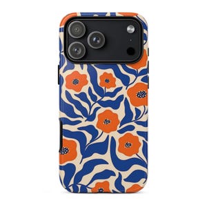 May include: A phone case with a floral pattern. The case features a cream-colored background with a repeating pattern of orange flowers and blue leaves. The phone's camera lenses are visible at the top.