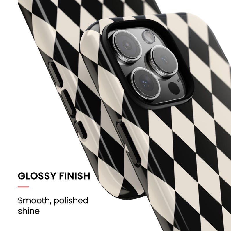 May include: A smartphone case featuring a black and cream harlequin diamond pattern with a glossy finish. The case has a smooth, polished shine and includes cutouts for the camera lenses and side buttons on the device frame.