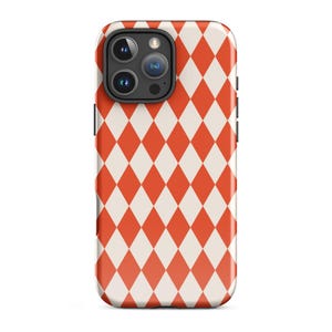 May include: A smartphone case featuring a repeating pattern of red and white diamonds. The case has a glossy finish and a black camera module. The design covers the entire back of the phone case.