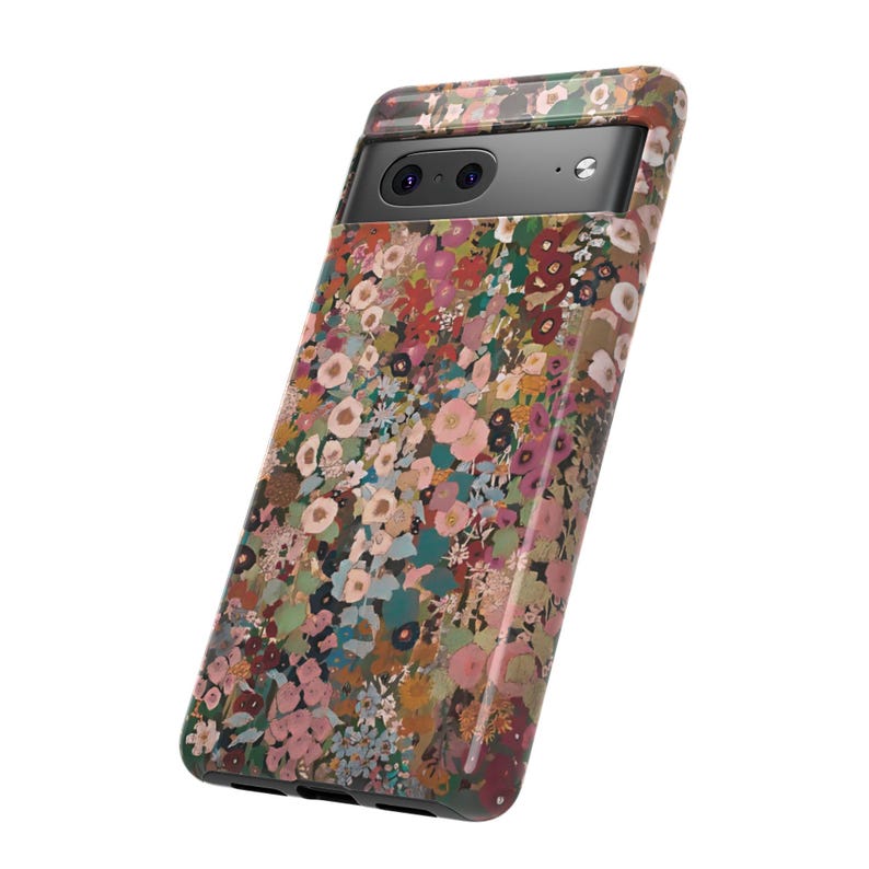 May include: A smartphone case featuring a dense, multi-colored floral pattern with shades of pink, red, green, and brown. The case has a black horizontal camera bar at the top with two circular lenses and a small flash, covering the back of the device.