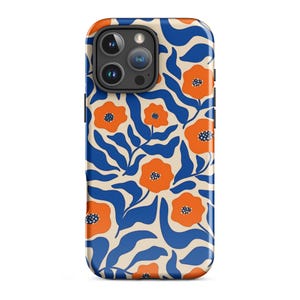 May include: A smartphone case featuring a repeating pattern of bright orange flowers with dark blue centers and wavy blue leaves set against a cream-colored background. The case has a cutout for a triple-lens camera system on the upper left side.