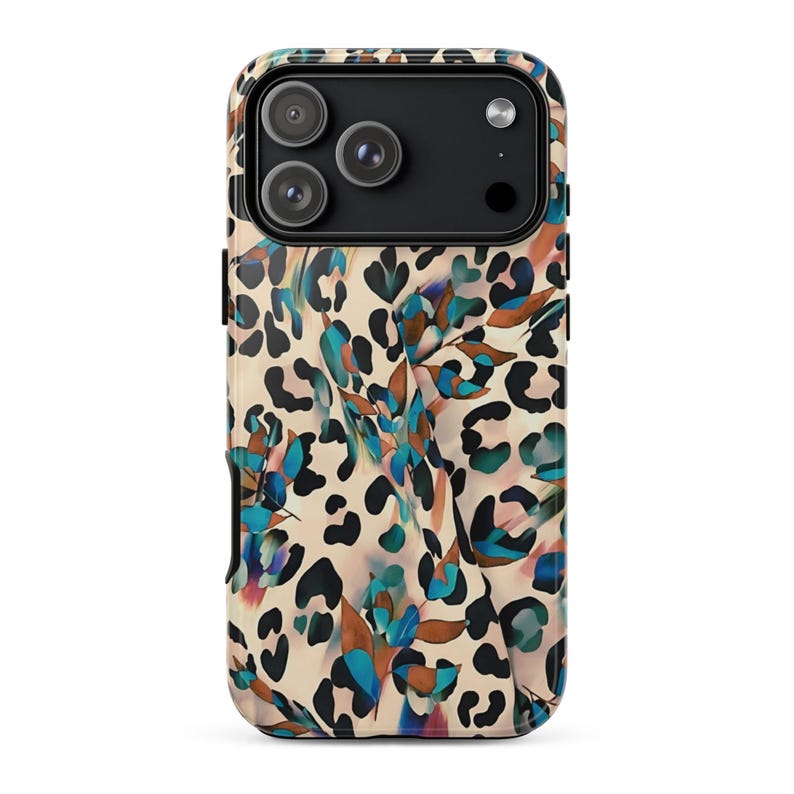 May include: A phone case with a leopard print design in tan, black, and brown. The case also features a floral pattern with blue, green, and purple accents. The phone case has a black camera module.